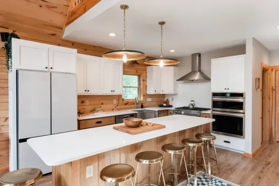 Every detail in this kitchen is designed for connection: double ovens for holiday feasts, a gas range for comfort meals, and a generous island where conversations flow as easily as the water pitcher in the refrigerator