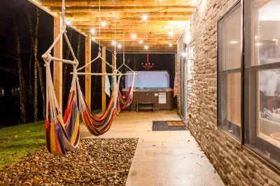 Café lights, hammocks, and a bubbling hot tub — it’s the grown-up version of summer camp, designed for evenings filled with laughter, relaxation, and a little stargazing