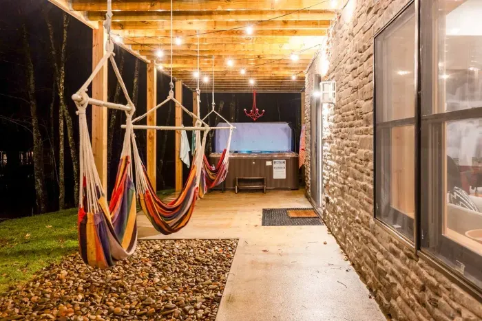 Café lights, hammocks, and a bubbling hot tub — it’s the grown-up version of summer camp, designed for evenings filled with laughter, relaxation, and a little stargazing