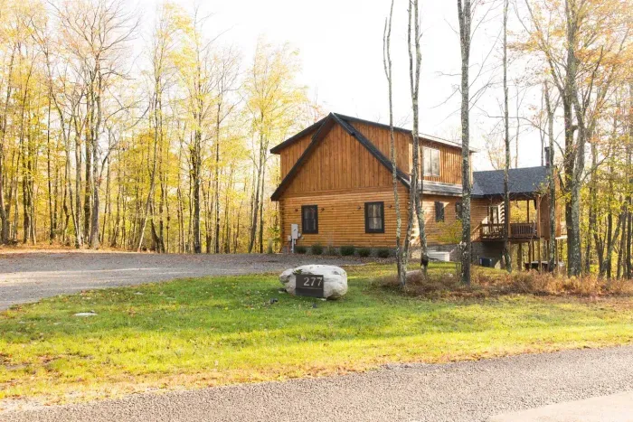 Arriving is effortless with a spacious drive and easy parking for multiple vehicles — perfect for family gatherings or ski trips