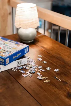 When the mood strikes, unfold the desk into puzzle mode—perfect for shared laughs, lighthearted competition, and listening in on the stories drifting up from below.  **Note to puzzlers - a puzzle lamp is tucked into the 'Golfers Green' closet!