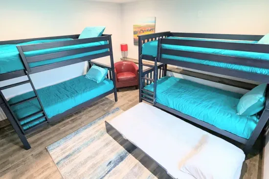 350 lb capacity for each sleeping surface; 
4 twin beds plus a trundle
(DOWNSTAIRS)