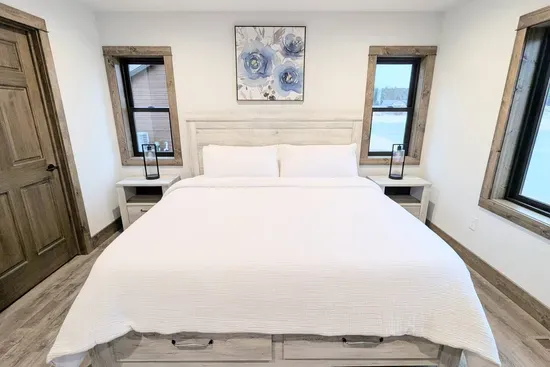 A beautiful king bed in the primary bedroom with adjoining full bathroom.
