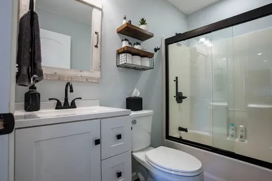 This bathroom includes a full sized tub and shower.