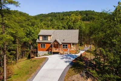 Exterior view of cabin showing ample parking space.