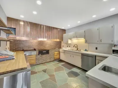 Lower Kitchen with copper hooded vent, and commercial griddle 