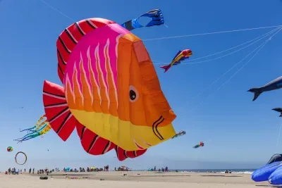 Large display kites including whales and sea creatures flying during the Lincoln City Summer Kite Festival