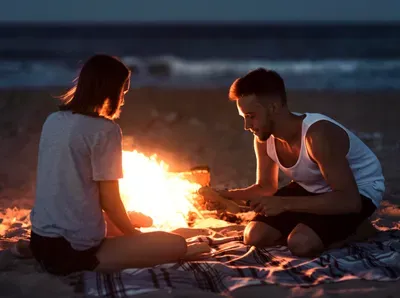 Couple enjoying a romantic beach fire near Netarts Bay on the Oregon Coast
