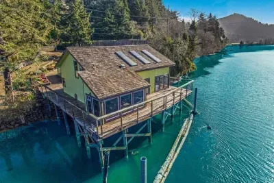 The house is surrounded by water on three sides amidst a wildlife sanctuary on the Siletz River