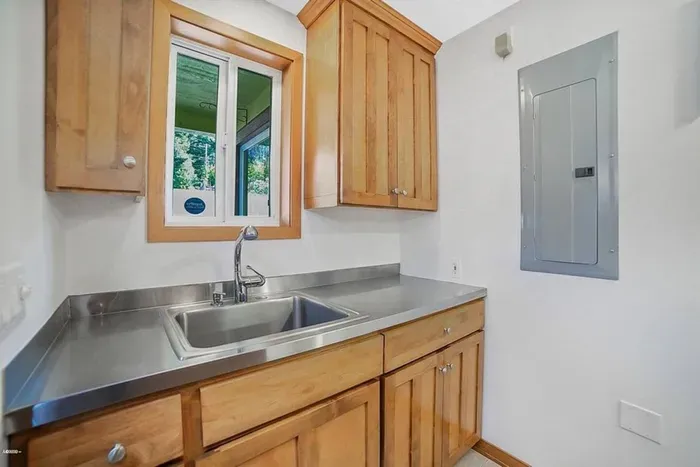 Separate laundry room with sink.