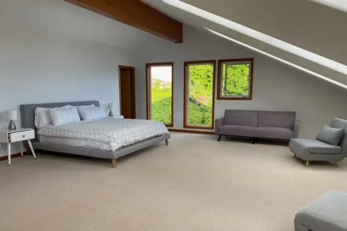 Huge upstairs master bedroom with separate seating area.