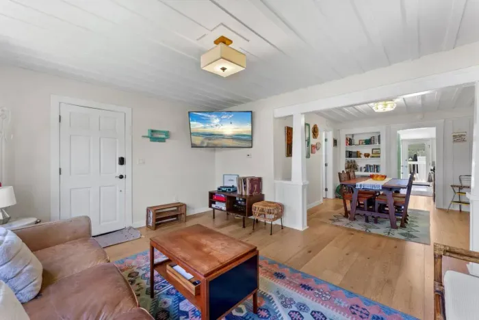 Open-concept living and dining area with boho charm, natural light, and plenty of space to gather.