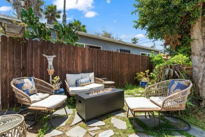 Private backyard oasis with cozy seating and fire pit for relaxing evenings.