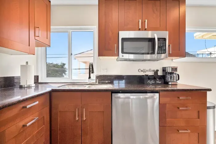 The kitchen has a microwave, dishwasher, and coffee bar!