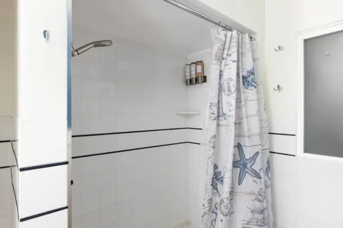 Large standing shower with soap, shampoo and conditioner