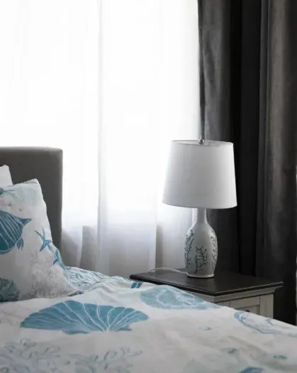 The primary bedroom is set up for comfort and relaxation. There are room darkening shades on all of the windows