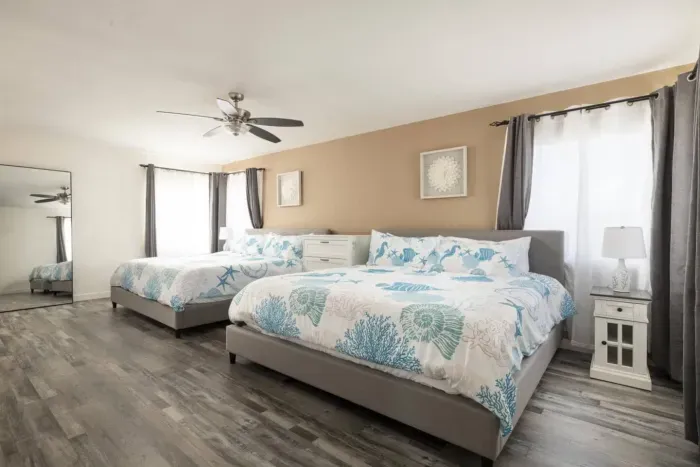 The primary bedroom has two king beds