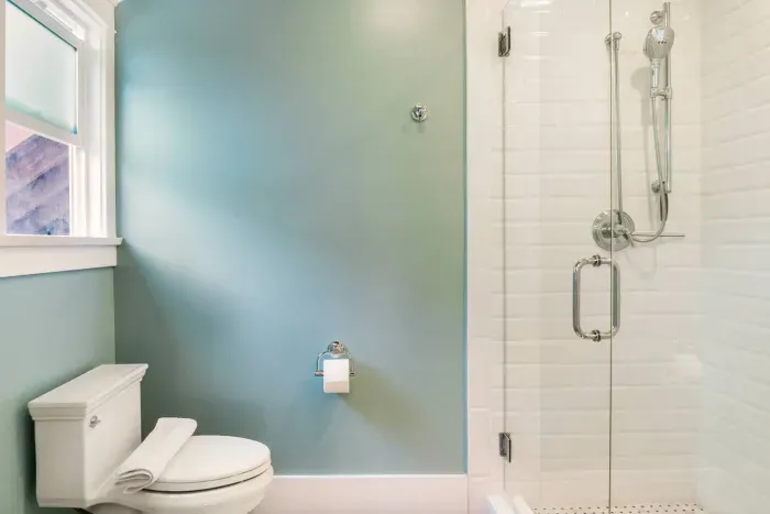Bathroom with a combined toilet and shower.