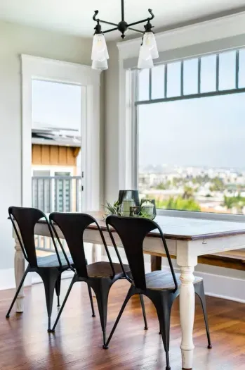 There are two balconies with seating next to the dining area.
