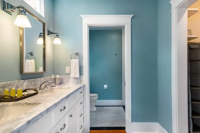 The primary bath with a walk in closet, double sinks and a separate toilet/shower area
