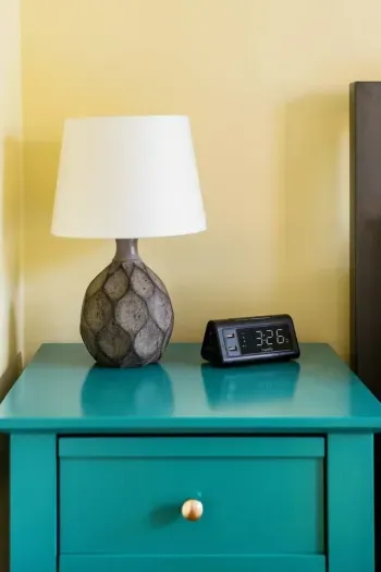 Convenient bedside clock and lamp for a cozy stay.