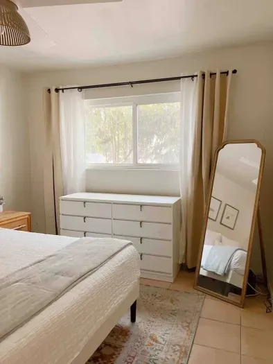 Wake up to a cozy bedroom bathed in warm morning sunlight.