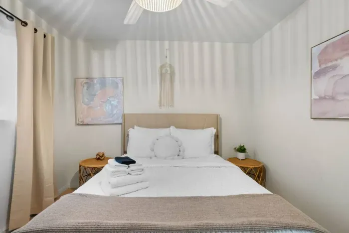 Cozy bedroom featuring a convenient side table for your bedside essentials.