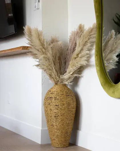 Woven vase with pampas grass adds a natural, modern touch to the living space.