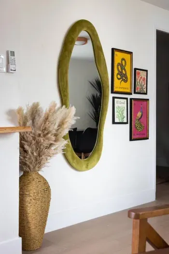 Curated design details bring warmth and charm—woven textures, bold Mexican artwork, and a statement mirror create a welcoming, stylish touch throughout the home.