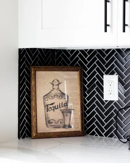 Playful tequila artwork adds a touch of personality to the modern kitchen.