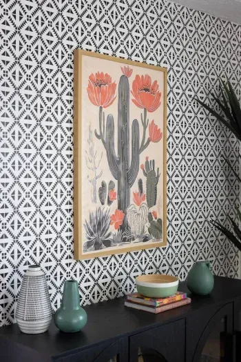 Bold cactus artwork and patterned accent wall bring vibrant character to the dining space.