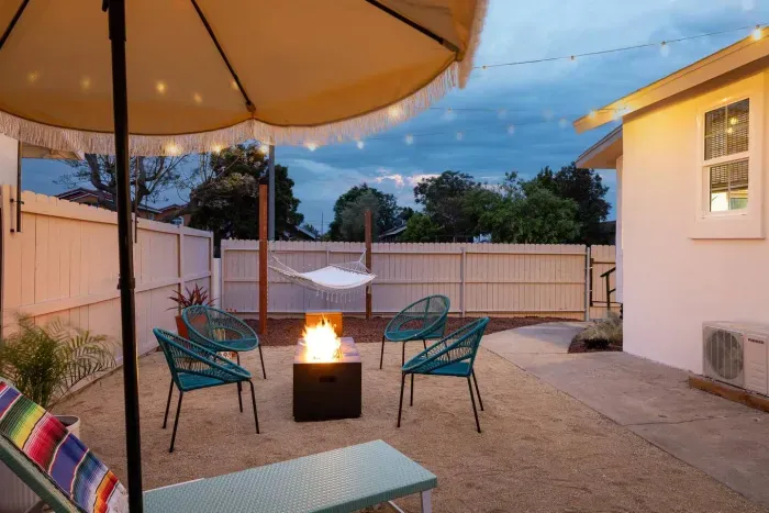 Relax in your private outdoor oasis with a cozy fire pit, hammock, and string lights—perfect for evening gatherings under the stars.