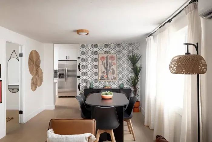 Stylish dining space with seating for six, bold accent wall, and plenty of natural light—perfect for shared meals and gatherings.