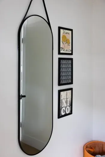 Minimalist mirror and vibrant Mexican-inspired artwork add style and personality to the room.