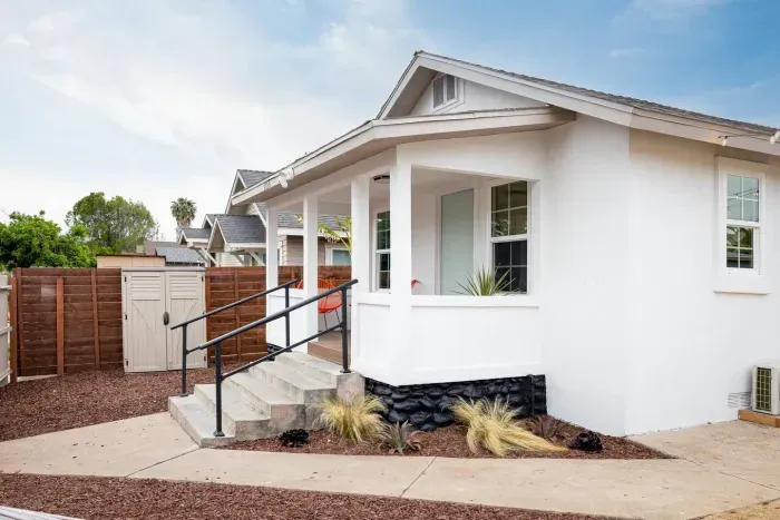 Charming front porch with modern touches and cozy seating—perfect for morning coffee or relaxing afternoons.