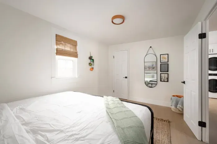 Bright and calming bedroom with cozy linens, natural textures, and thoughtful decor—perfect for a restful night’s sleep.