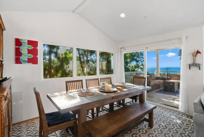 Dining area with balcony access for scenic meals.