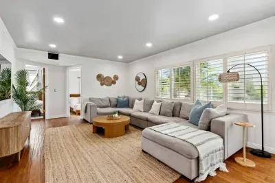Spacious, cozy living room featuring a sectional sofa and a smart TV.