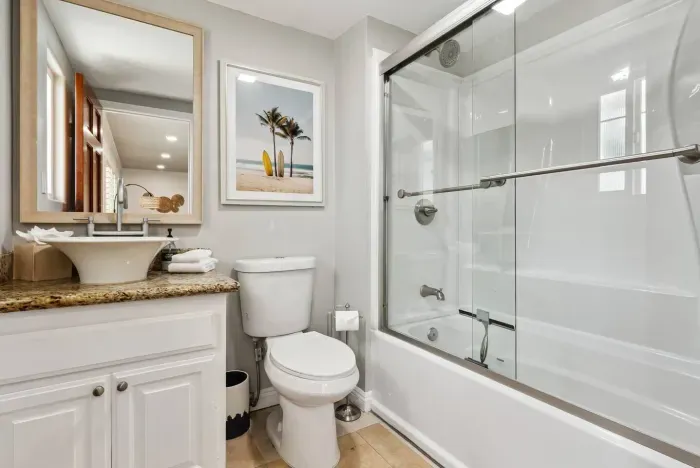 Updated bathroom with glass shower enclosure.