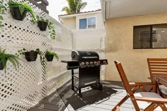 Private balcony with grill and outdoor seating.
