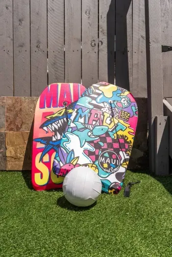 Brightly designed boogie boards and volleyball for outdoor adventures.