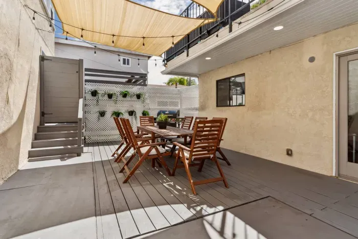 Covered patio dining area with seating for gatherings.