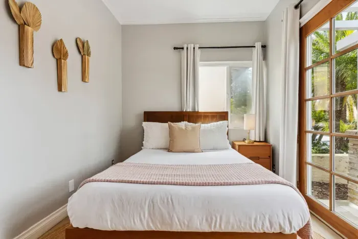 Cozy bedroom with soft linens and neutral tones.