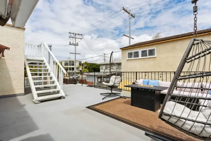 Rooftop terrace with sectional seating and outdoor vibe.