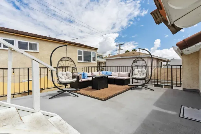 Rooftop lounge with cushioned seating and panoramic views.