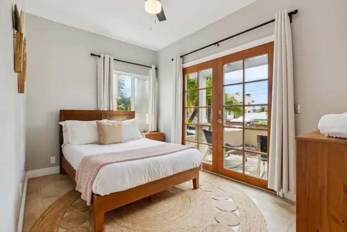Bright bedroom with natural light and balcony access.