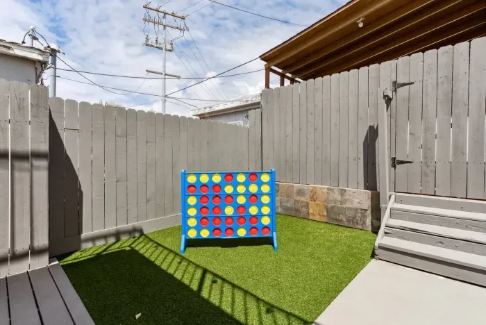 Private outdoor corner with a life-size Connect Four game for family fun.
