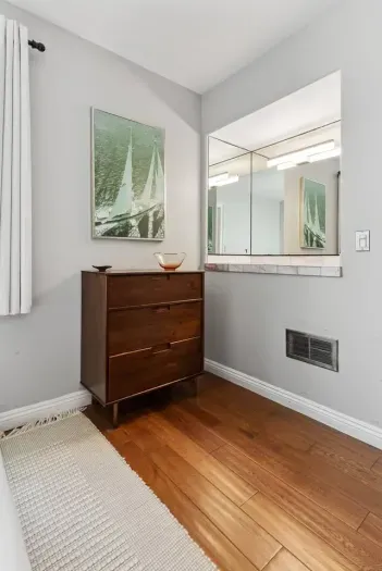 Modern with sleek vanity and bright lighting.