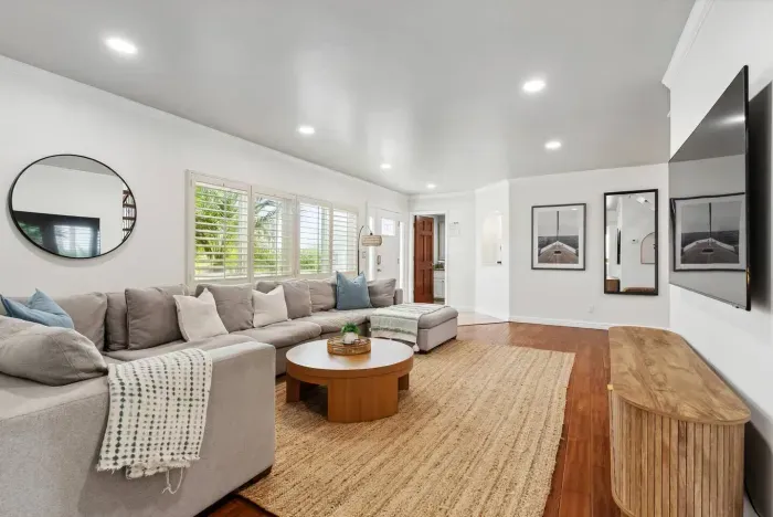 Open layout living room with hardwood floors.