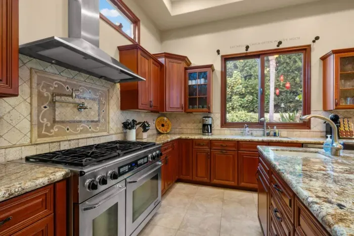 Kitchen with range, hood, and modern appliances.